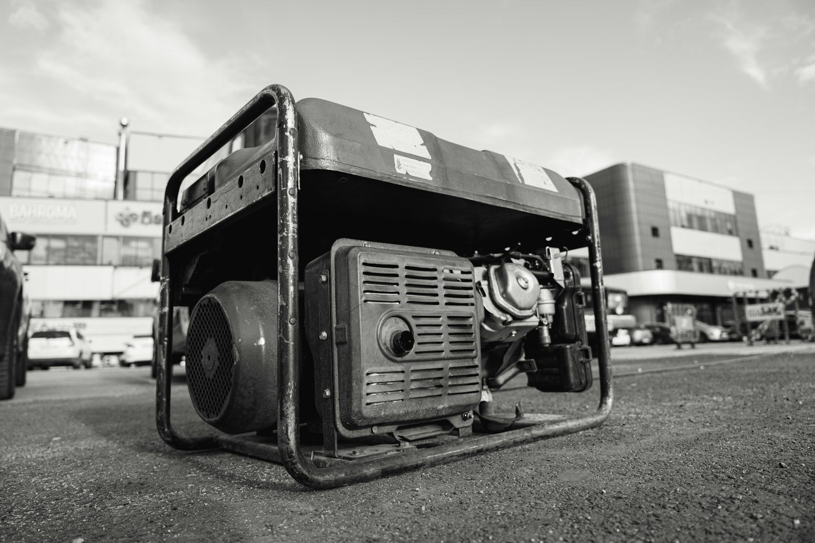 An open-frame portable generator on a parking lot